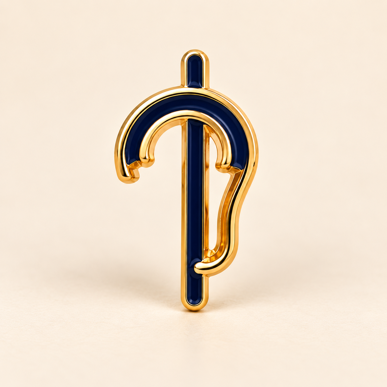 Small gold-tone outline ear pin with navy inlay